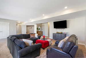 Living room with a textured ceiling and light colored carpet