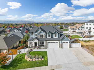 View of front of property with a front yard and a garage