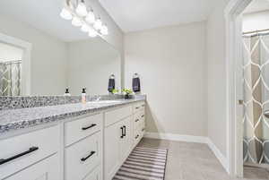 Bathroom featuring vanity and tile patterned floors