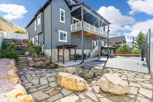 Rear view of property with central AC unit, an outdoor fire pit, and a patio area