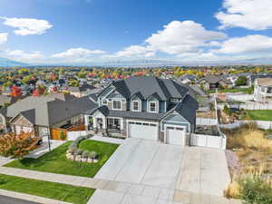 View of front of house with a garage and a front lawn