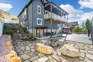 Rear view of house with a patio area and an outdoor fire pit