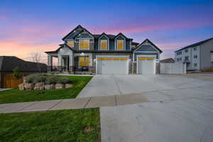 Craftsman-style house featuring a lawn and a garage