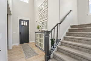 Foyer with a high ceiling and LVP- flooring