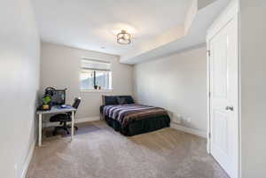 Carpeted bedroom with a textured ceiling