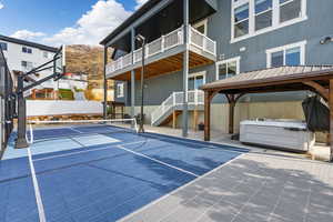 View of sport court featuring a mountain view, pickle-ball court, and a gazebo