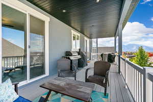 Wooden trex deck featuring a mountain view and area for grilling