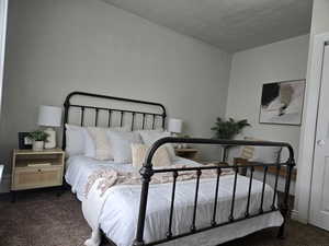 Carpeted bedroom featuring a textured ceiling