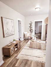 Corridor featuring hardwood / wood-style floors and a textured ceiling