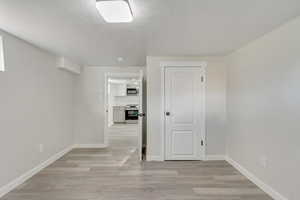 Spare room featuring light wood-type flooring