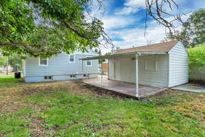 Back of house featuring a patio, central AC, and a yard