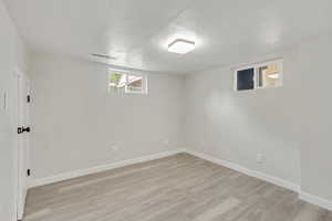 Basement featuring light hardwood / wood-style flooring