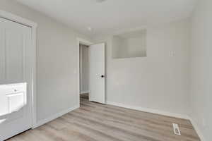 Unfurnished bedroom with light wood-type flooring