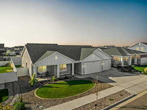 View of front of house with a garage and a lawn