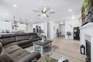 Living room featuring light hardwood / wood-style floors and ceiling fan