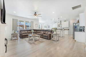 Living room featuring light hardwood / wood-style flooring and ceiling fan