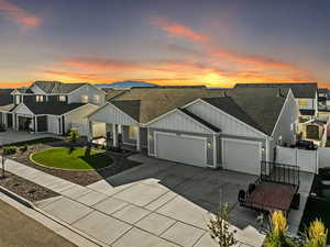 View of front of house with a garage and a yard