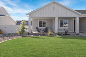 Back of house featuring a lawn