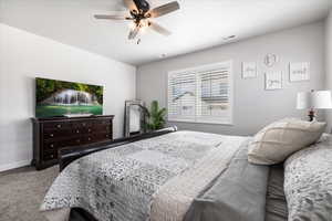 Bedroom featuring ceiling fan and carpet flooring