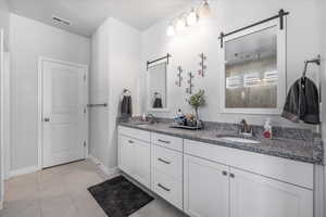 Bathroom featuring vanity and tile patterned floors