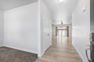 Hall featuring recessed lighting, light wood-style flooring, and baseboards