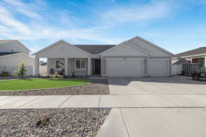 View of front of property with a garage and a front yard