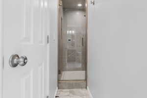 Bathroom featuring a shower with door