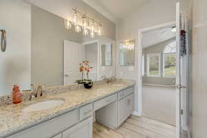 Upgraded masterbathroom featuring LVP flooring, double-sink granite countertop vanity