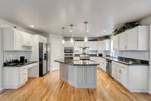 Upgraded kitchen with island, granite countertop, amble cabinets and office desk