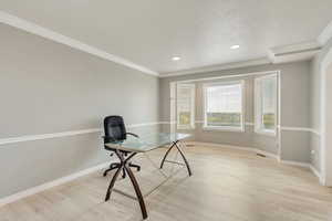 Large living room that can be used as office, LVP flooring and crown molding