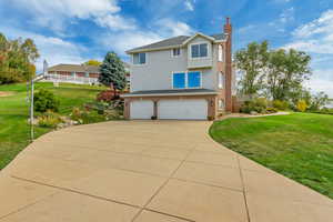 View of front of house featuring a garage and a front lawn