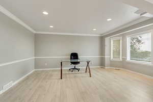 Large living room that can be used as office, LVP flooring and crown molding