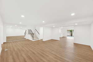 Basement with light hardwood / wood-style floors