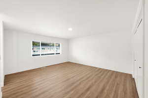 Unfurnished bedroom featuring light hardwood / wood-style floors and a closet