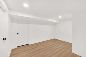 Empty room with light hardwood / wood-style flooring