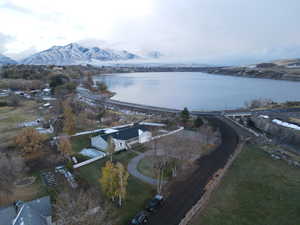 Drone / aerial view featuring a water and mountain view