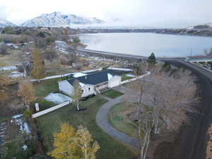 Birds eye view of property with a water and mountain view