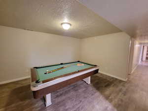 Recreation room with hardwood / wood-style flooring, billiards table, and a textured ceiling