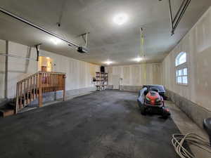 Huge garage featuring a garage door opener and heater