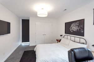 Carpeted bedroom with a closet