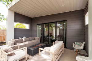 View of patio featuring an outdoor living space with a fire pit