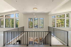 Corridor with a healthy amount of sunlight and lofted ceiling