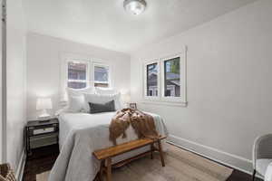 Bedroom 1 with original hardwood floors, main level