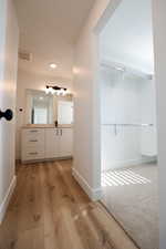 Bathroom with hardwood / wood-style floors and vanity