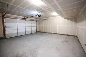 Garage featuring a garage door opener