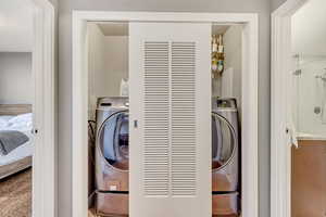 Laundry room with carpet floors and washer / dryer