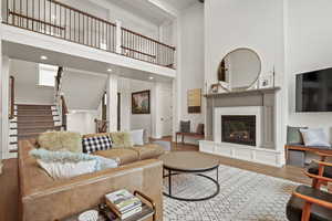 Living room featuring a high ceiling and hardwood / wood-style floors