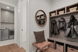 Mudroom featuring light hardwood / wood-style flooring and separate washer and dryer