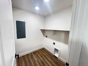 Clothes washing area featuring electric panel, dark hardwood / wood-style flooring, electric dryer hookup, and hookup for a washing machine