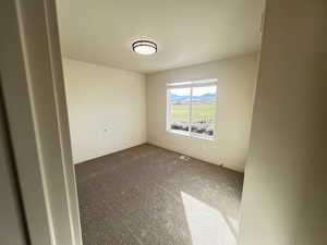 Unfurnished room with carpet